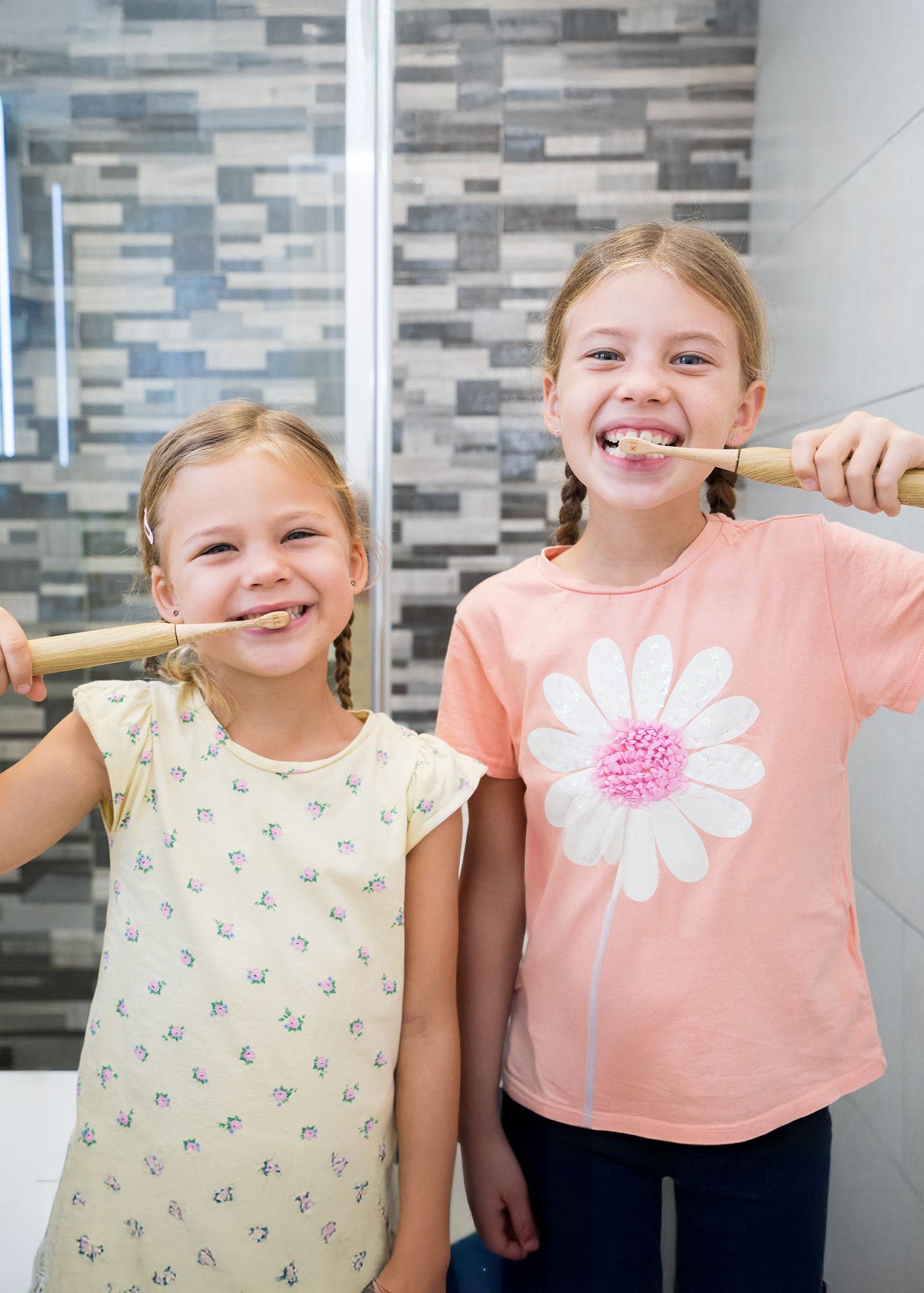 Two Kids using the Junior Bamboo Electric Toothbrush Designed for Kids