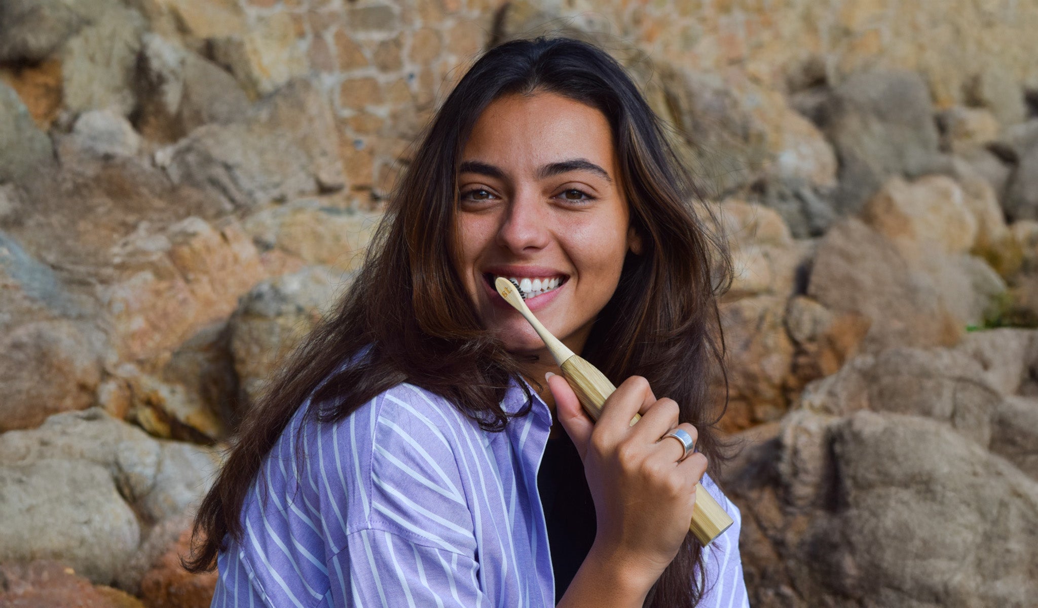 A women using the Zen Bamboo Electric Toothbrush